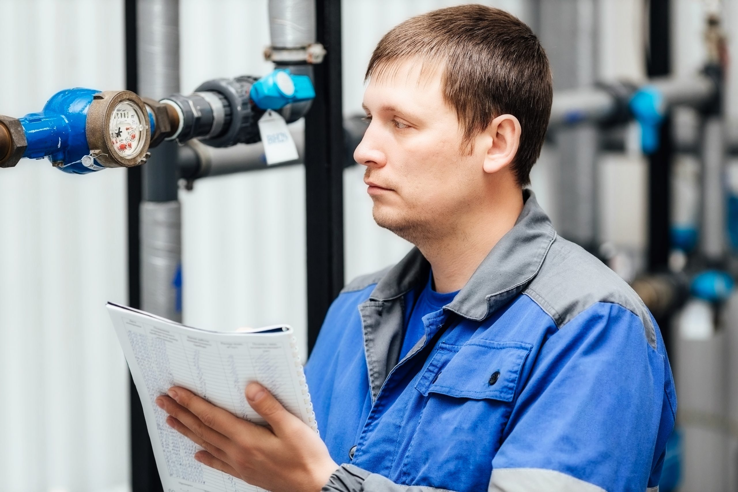 Engineer, worker registers readings of sensors and pressure gauges. Control of water supply and heating system. Checking the equipment before the start of the heating season